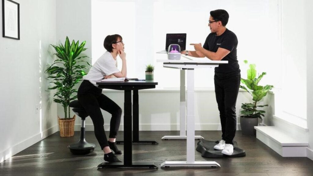 couple talking over standing desks
