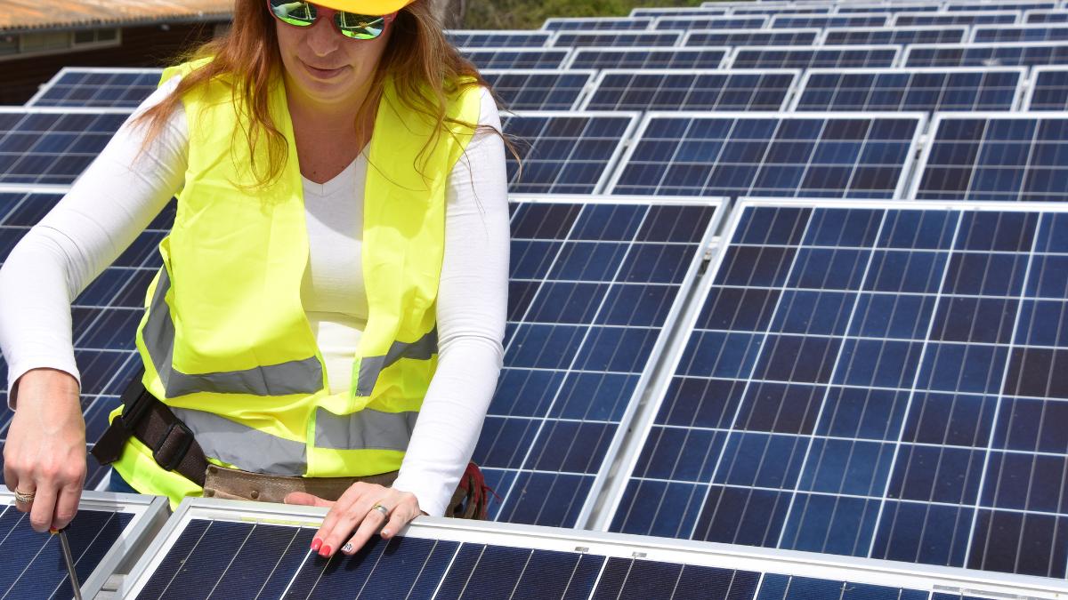 woman installing solar panel