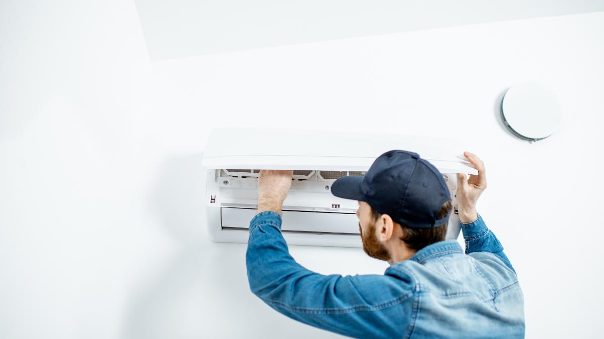 Worker checking on ac