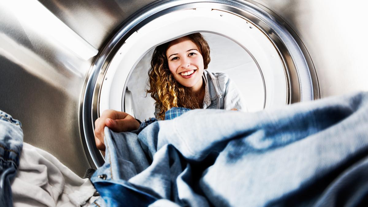girl getting clothes in a dryer
