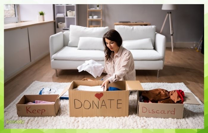 a woman separating clothes for donation, discard and keep