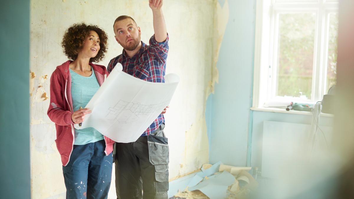 couple holding a home remodeling plan