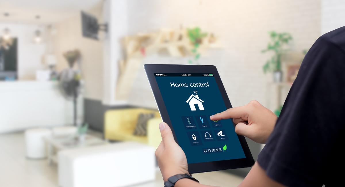 Guy holding ipad with home control