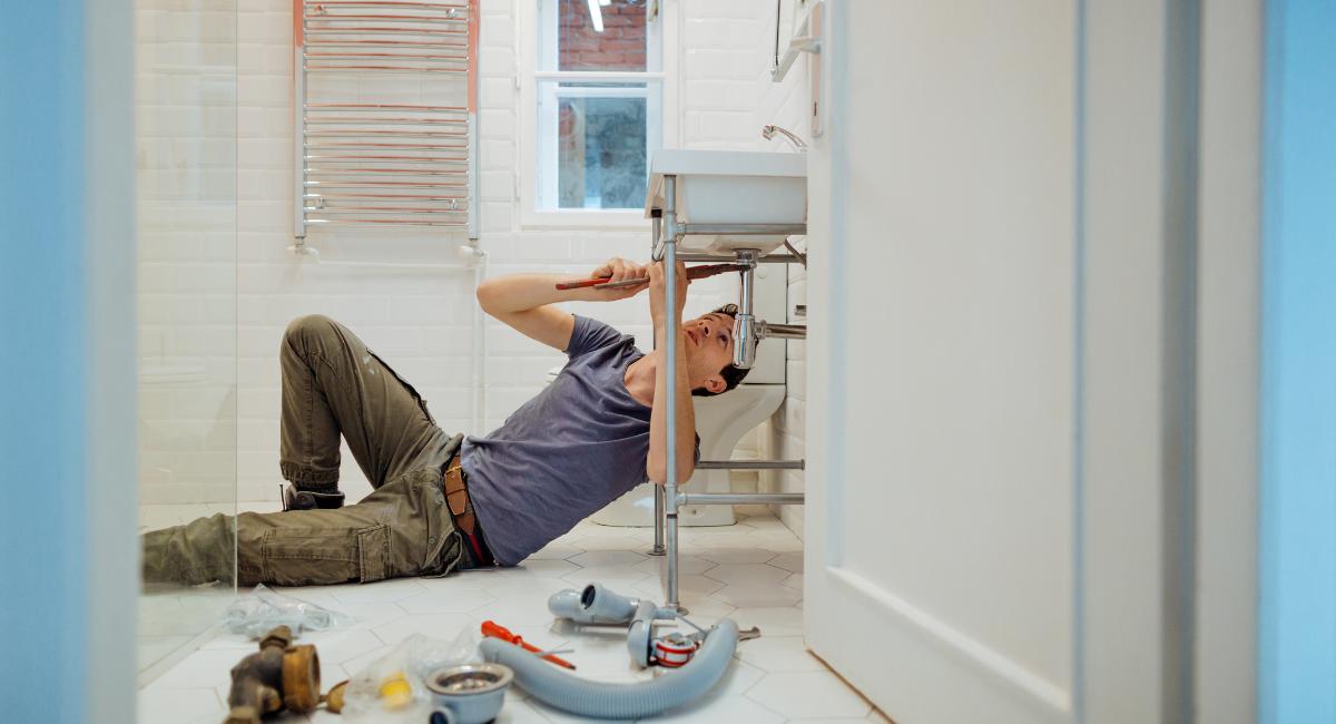 guy fixing under sink