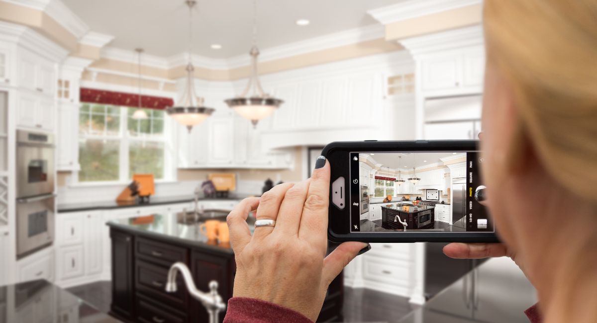 woman taking photo of the kitchen