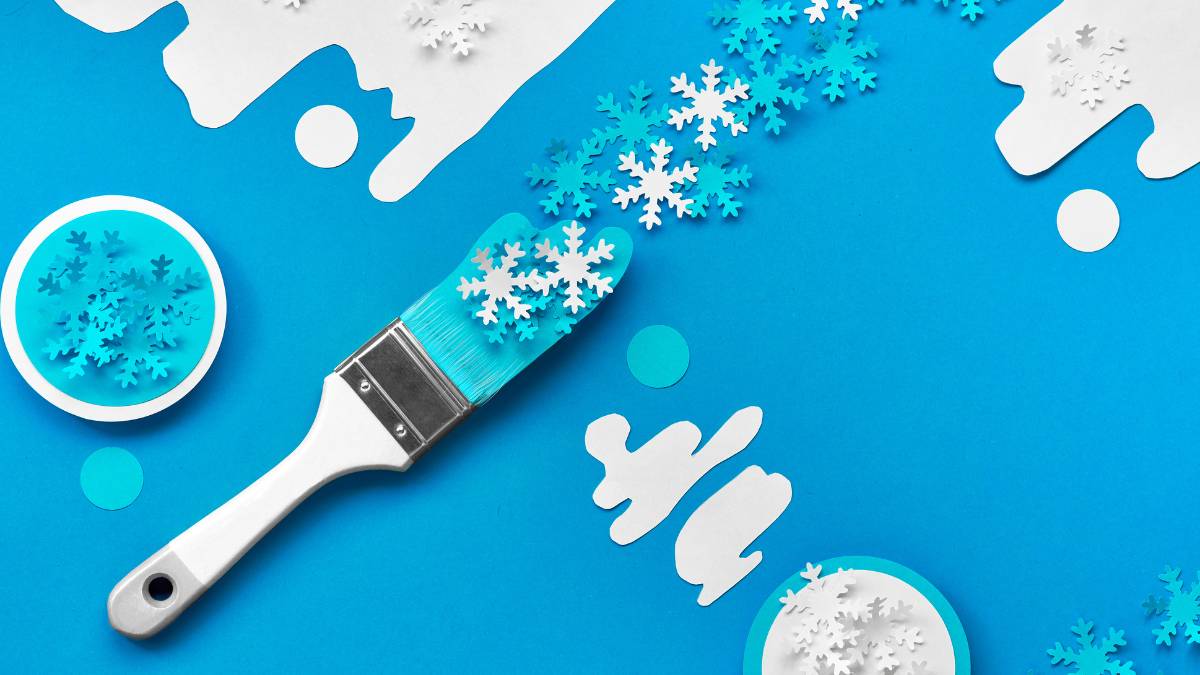 brush with blue paint and snowflakes