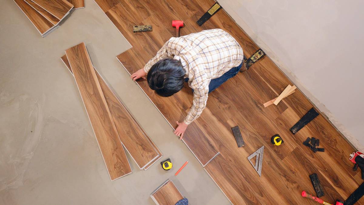 man installing vinyl floors