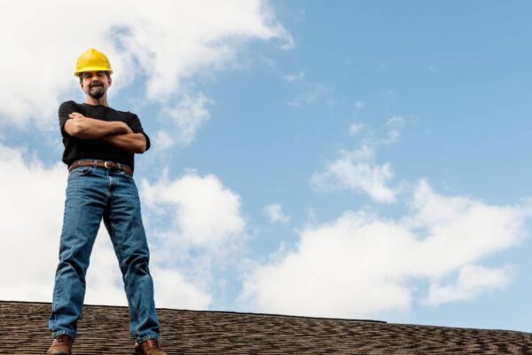 worker standing in the roof with hands on chest
