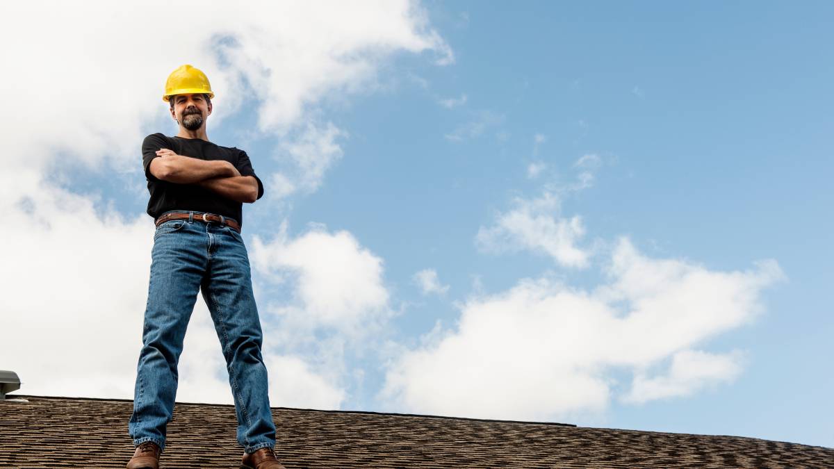 worker standing in the roof with hands on chest
