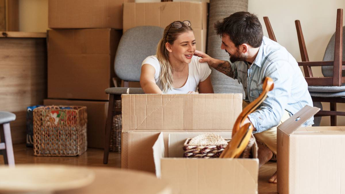 couple working on boxes for moving