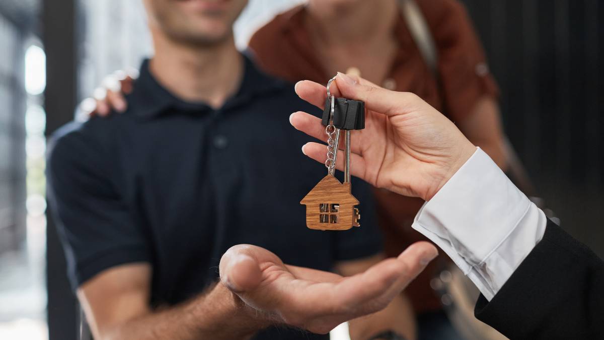 real estate agent handing house keys