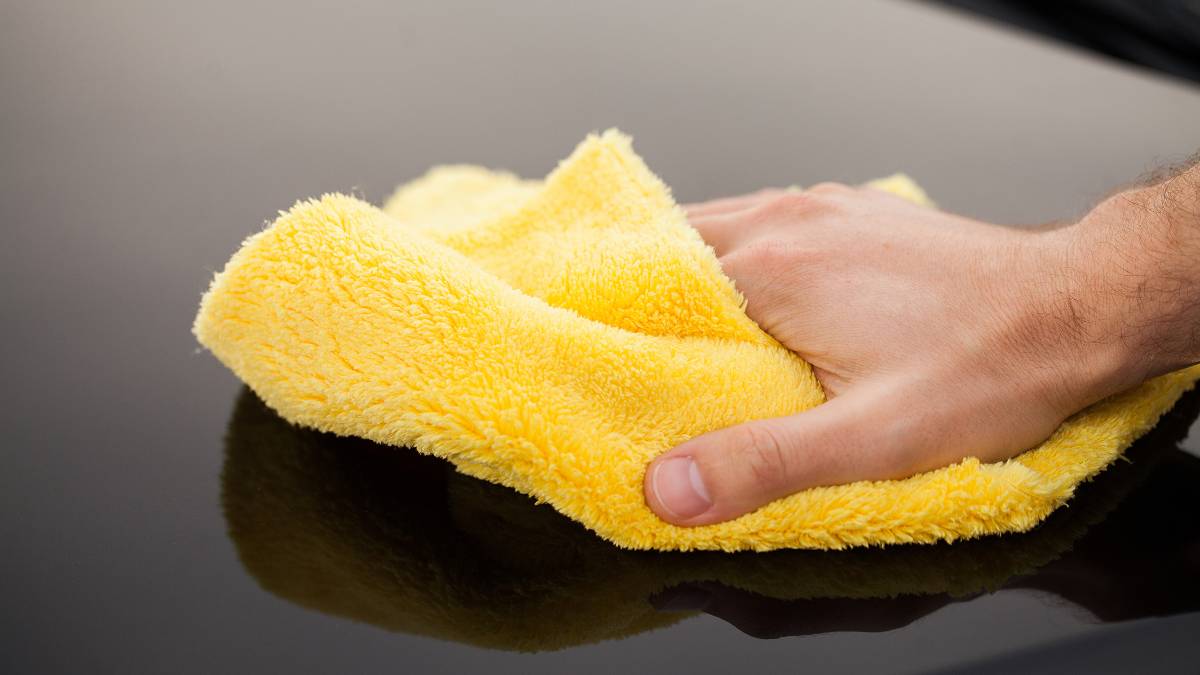 table being cleaned by microfiber cloth