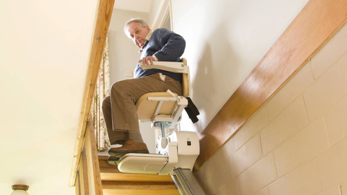 senior riding a stair lift