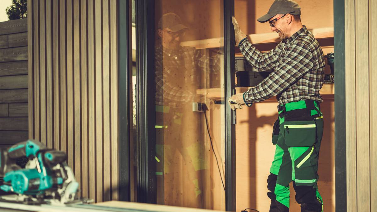 worker installing custom glass door