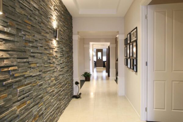 Well-lit hallway with stone wall
