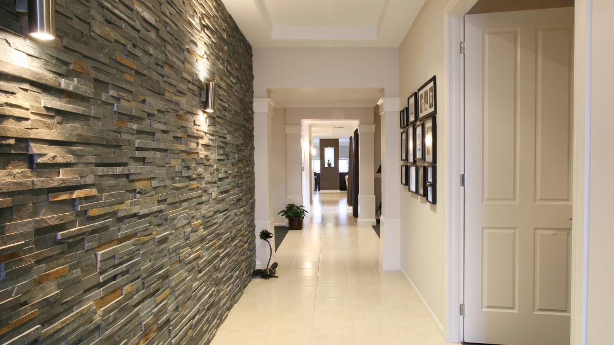 Well-lit hallway with stone wall