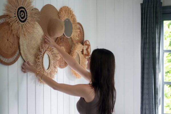 Woman decorating wall with native products