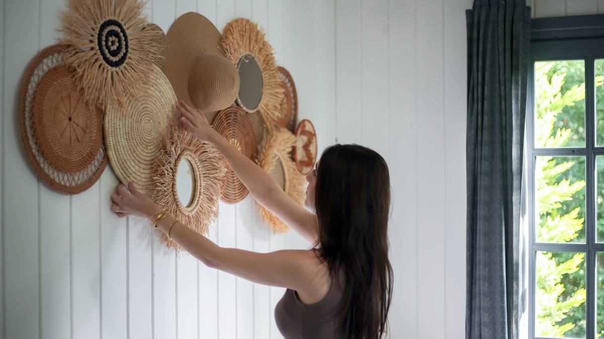 Woman decorating wall with native products