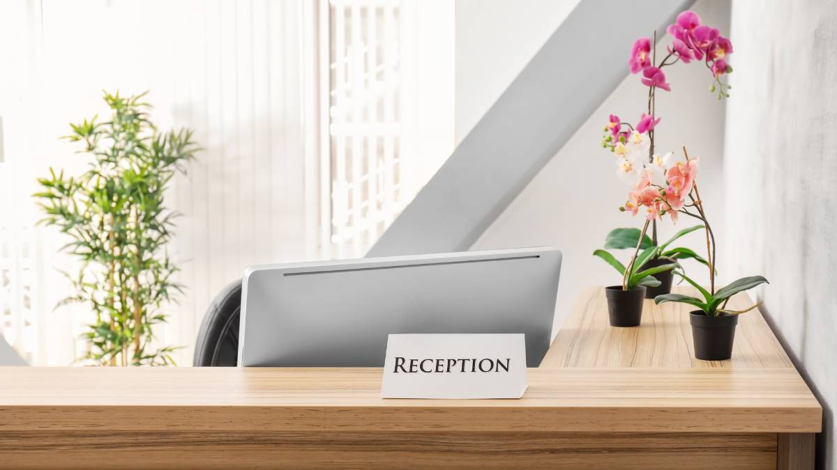 reception desk with flowers on pot