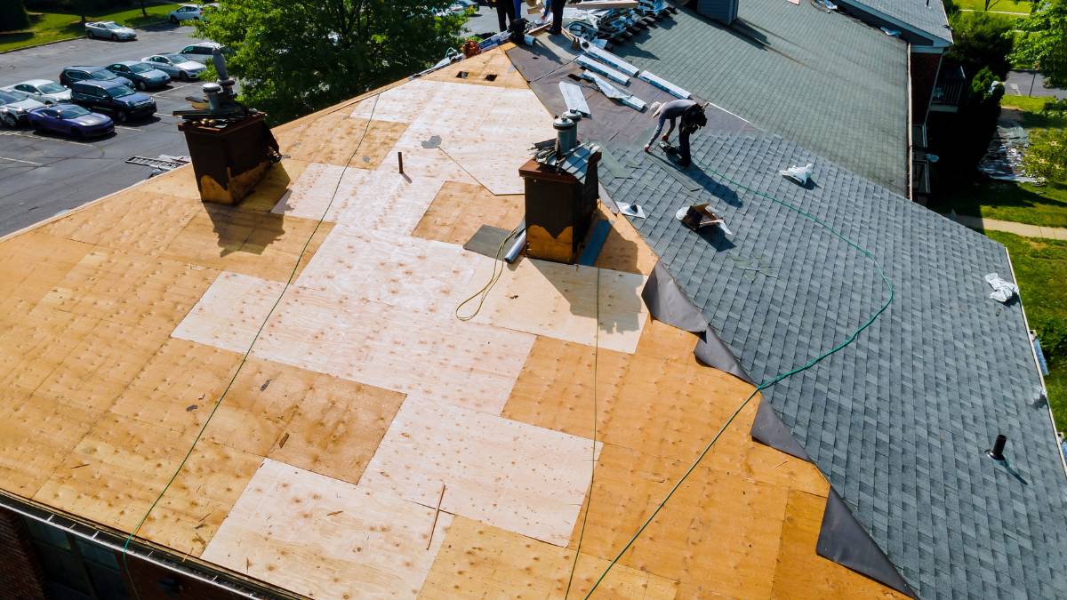 workers working on a roof replacement