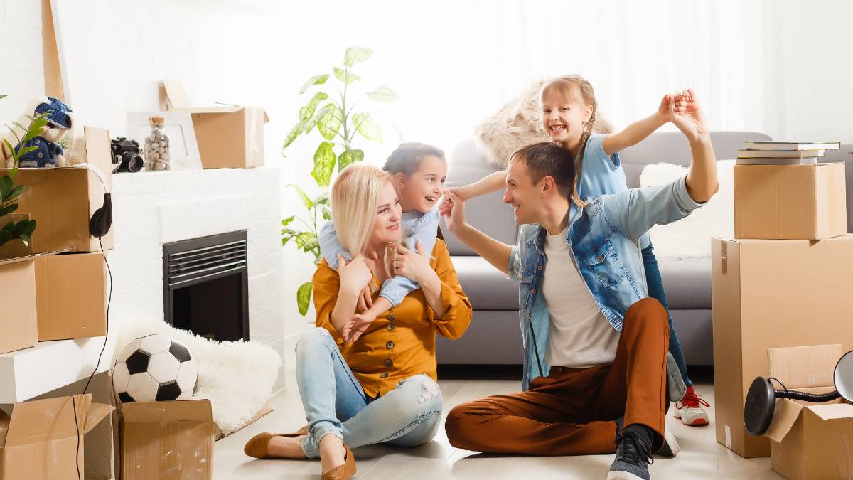 couple playing with their two kids in the living room