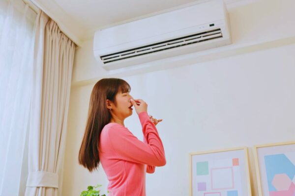 Girl covering her nose due to bad ac smell