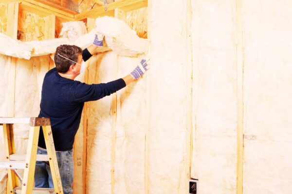 guy installing an insulation on a wall
