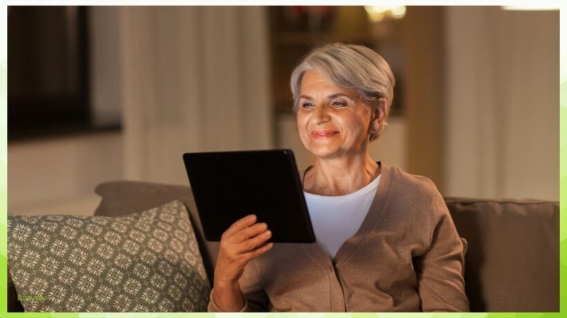 Senior sitting at home with tablet in hand