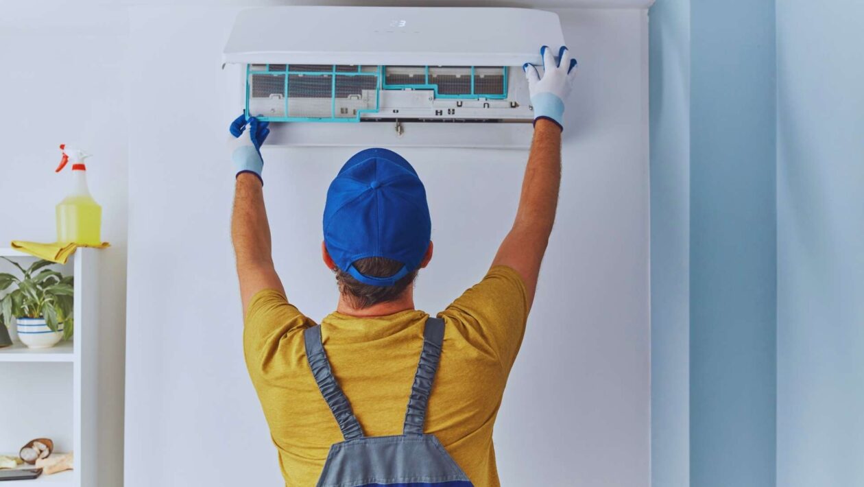 a HVAC specialist checking on an AC