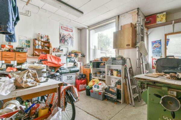 Cluttered room in need of old furniture removal in Sydney.