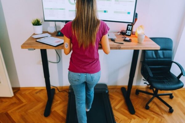 woman working on something in a standing desk