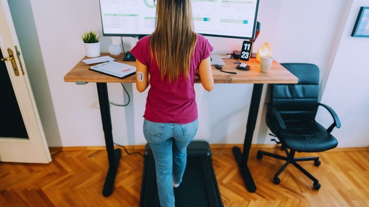 woman working on something in a standing desk