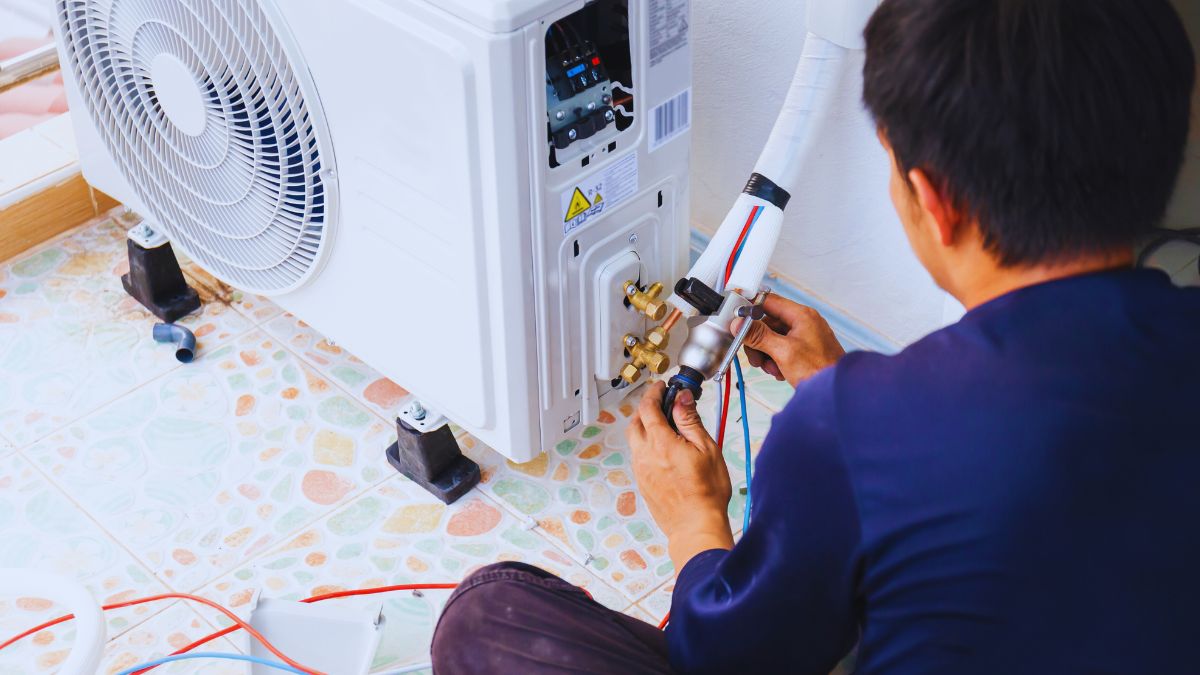 Worker installing AC