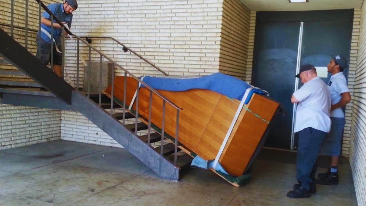 movers moving a grand piano