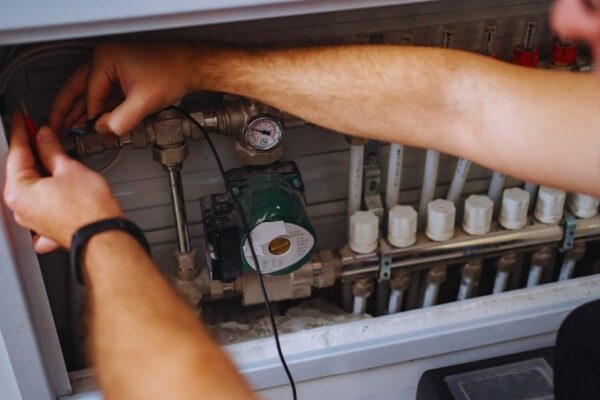 worker fixing a heating system