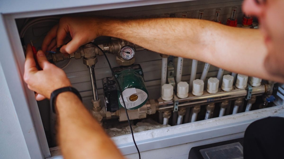 worker fixing a heating system